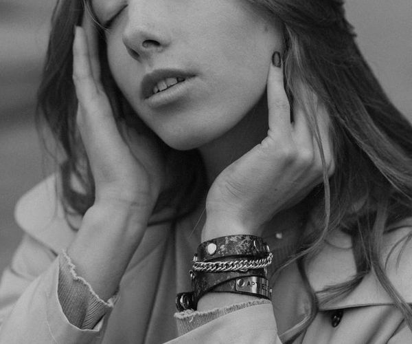 Person in a meditative pose with soft focus background.